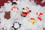 Six mini Christmas squishy toys scattered in snow with Santa and reindeer designs