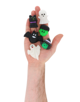 Hand holding six mini Halloween squishy toys with spooky assorted designs