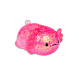 Pink glitter axolotl squishy lying on white background showing holographic sparkle finish
