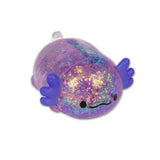 Purple glitter axolotl squishy lying on white background showing iridescent gel body