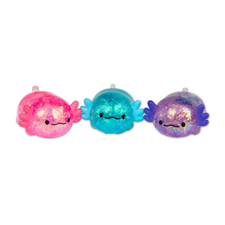 Pink, blue and purple glitter axolotl squishies displayed together in a row