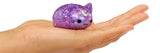 Purple glitter kawaii cat Moj Moj crunch squishy toy resting on an open palm to show size