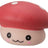 Close-up of red kawaii squishy mushroom fidget toy with white spots and smiling face