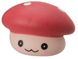 Close-up of red kawaii squishy mushroom fidget toy with white spots and smiling face