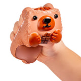 Hand squeezing MushyKinz Button the Bear taba squishy, soft sensory fidget toy