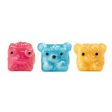 Three small translucent animal-shaped figurines on a plain white background: a pink frog on the left, a blue bear in the center, and a yellow tiger on the right.