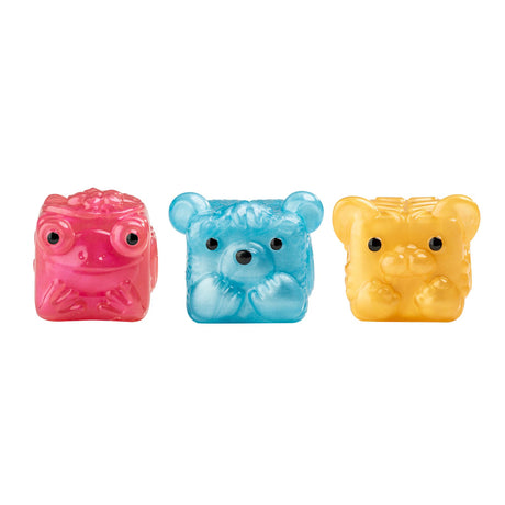 Three small translucent animal-shaped figurines on a plain white background: a pink frog on the left, a blue bear in the center, and a yellow tiger on the right.