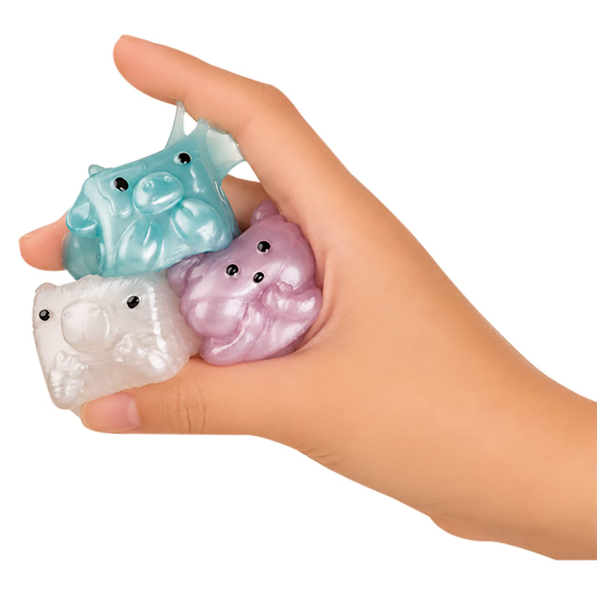 Three small translucent animal-shaped stress toys held in a hand against a plain white background. The toys have black bead eyes and are in pastel aqua, lavender, and translucent white.