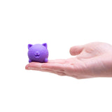 Purple Jinxy Nee Doh Cool Cat squishy resting in an open palm to show size