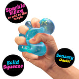Blue Nee Doh Dream Drop being squeezed in a fist showing glitter sparkle fill and solid gel texture