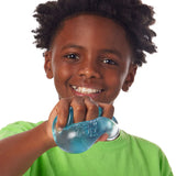 Blue Nee Doh Nice Cube being fully squeezed in a fist showing gel deformation
