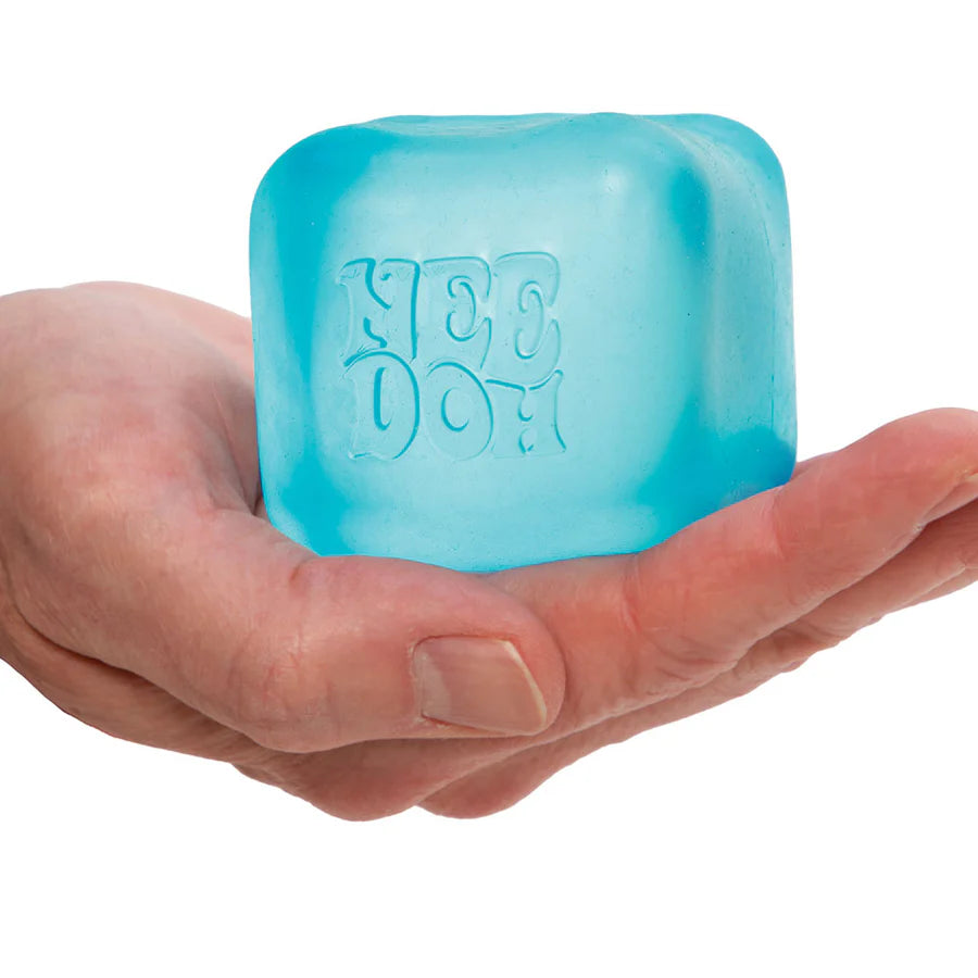 Blue Nee Doh Nice Cube resting on an open palm showing size and cube shape