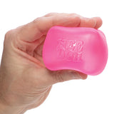 Pink Nee Doh Nice Cube being gripped in a hand showing the squishable gel body