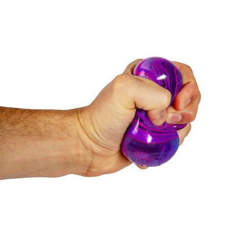 Purple marbled Nee Doh Nice Cube Swirl being squeezed in a fist showing gel deformation