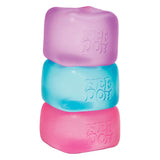 Three Nee Doh Nice Cubes stacked in purple, blue and pink on a white background