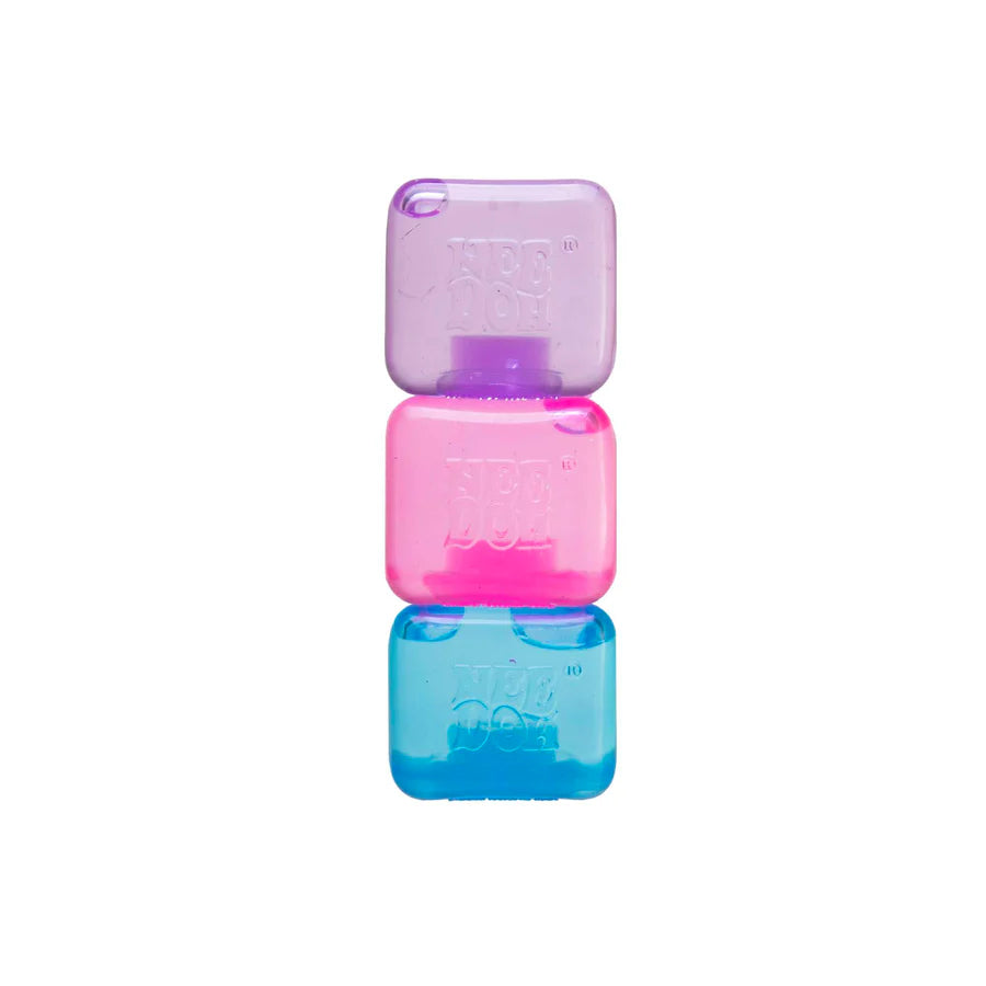 Three Nee Doh Nice Ice Baby squishy cubes stacked in purple, pink and blue