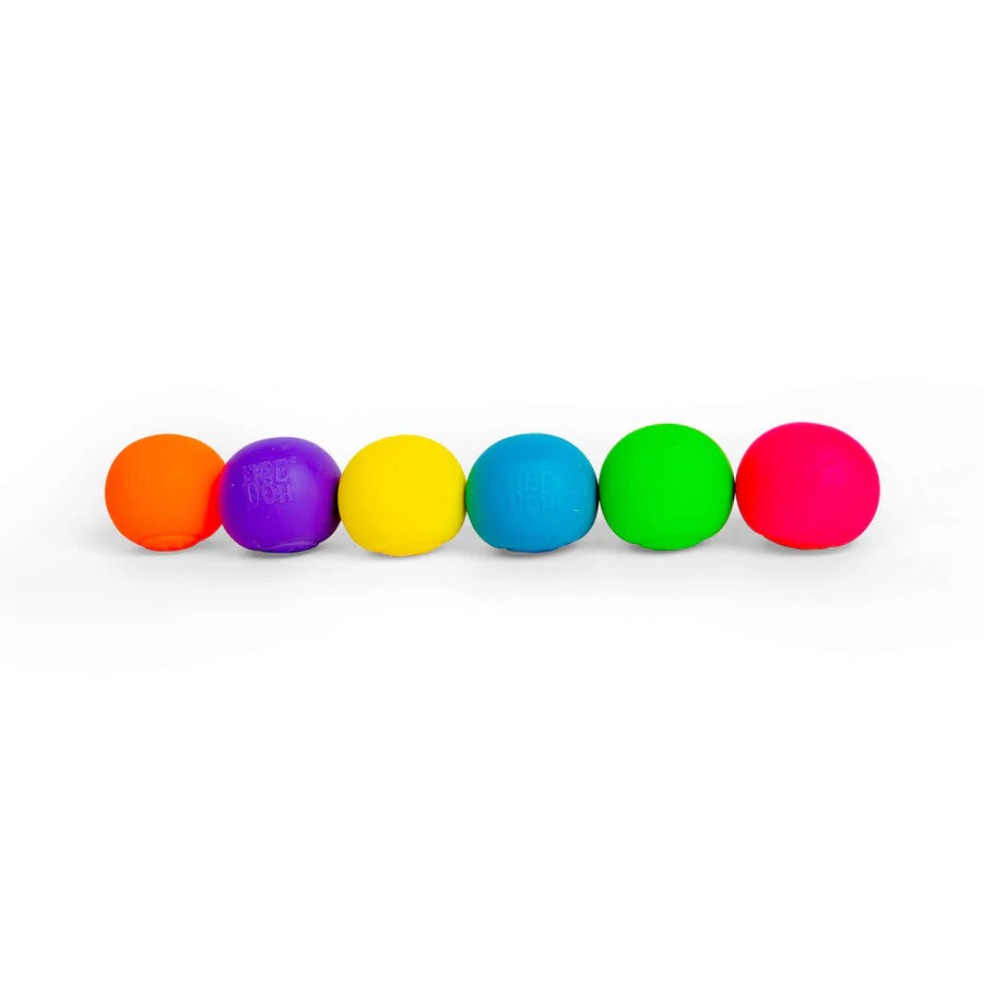 Six Nee Doh Rainbow Teenie squish balls lined up in a row showing all six colours