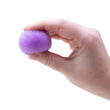 Hand holding a purple Nee Doh Teenie Fuzz Ball showing its soft spiky texture