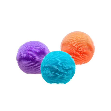 Three Nee Doh Teenie Fuzz Balls in purple, teal and orange grouped together