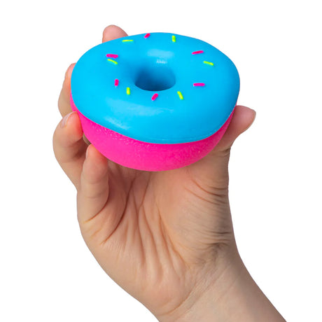 Hand holding blue sprinkle NeeDoh Dohnut squishy sensory toy from below