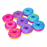 Nine NeeDoh Dohnut squishy toys scattered in assorted pink, purple and blue colours and frosting designs