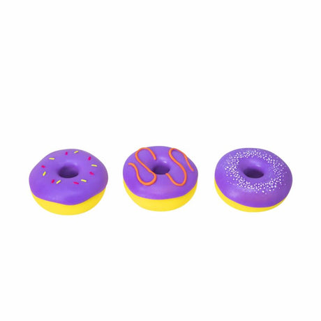 Three purple NeeDoh Dohnuts showing sprinkle, drizzle and pearl frosting designs
