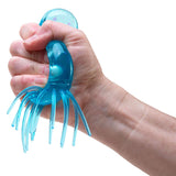 Hand squeezing blue NeeDoh Jelly Squish jellyfish fidget toy in a fist