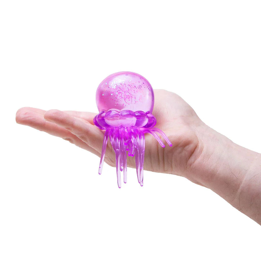 Purple NeeDoh Jelly Squish jellyfish sensory toy resting on an open palm