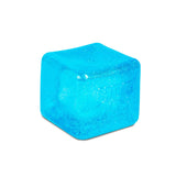 Close-up of blue Nee Doh Nice Berg Glitter and Glow squish cube showing shimmering glitter texture on white background