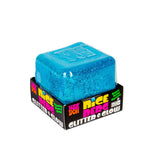 Blue Nee Doh Nice Berg Glitter and Glow squish cube sitting on top of its branded retail box
