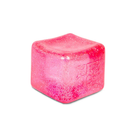 Close-up of pink Nee Doh Nice Berg Glitter and Glow squish cube showing sparkling glitter texture