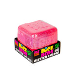Pink Nee Doh Nice Berg Glitter and Glow squish cube sitting on top of its branded retail box