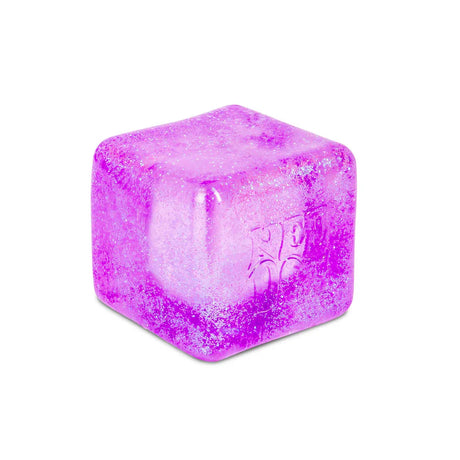 Close-up of purple Nee Doh Nice Berg Glitter and Glow squish cube showing iridescent glitter suspended inside