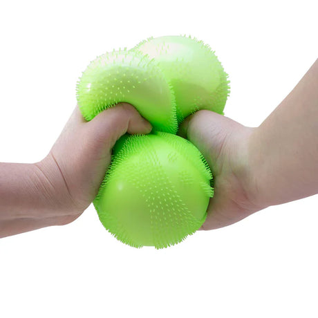 NeeDoh Super Fuzz Ball green sensory squeeze toy, two hands squishing