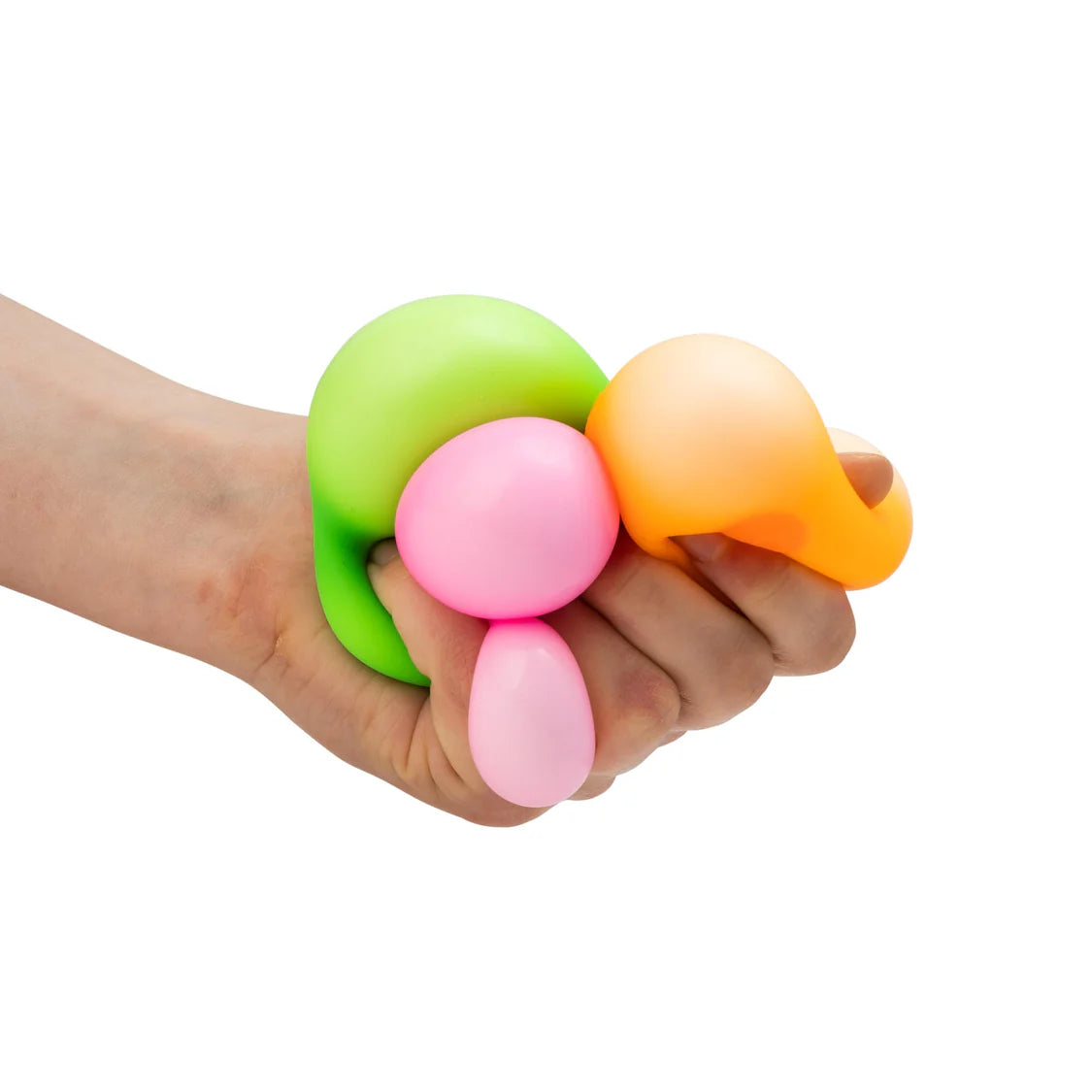 Adult hand squeezing all three neon squish balls together — lime green, pink and orange bulging between fingers