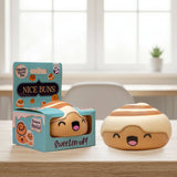 Kawaii cinnamon roll squishy stress toy next to its teal Nice Buns gift box on a wooden table