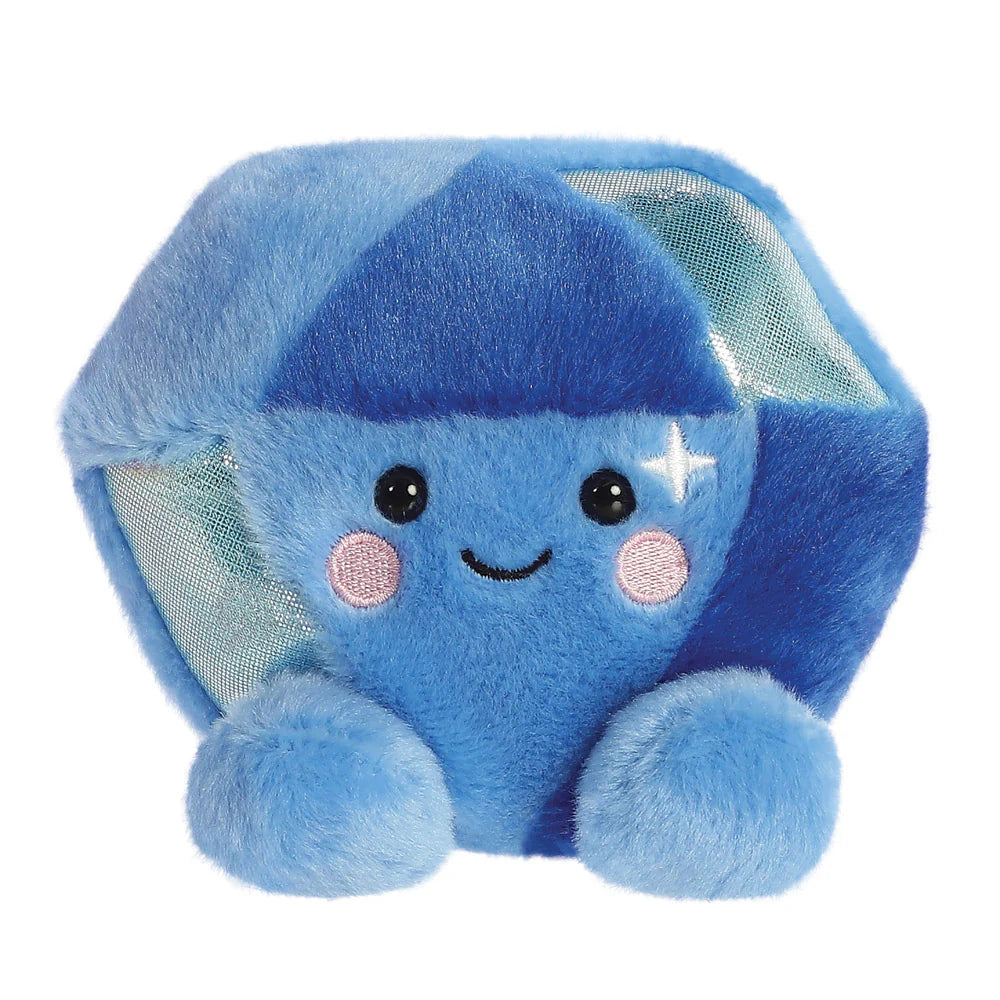 Aurora Palm Pals Alice Sapphire plush — a blue hexagonal gem-shaped soft toy with shimmery facets, rosy pink cheeks, a sparkle detail, and a cute smiling face