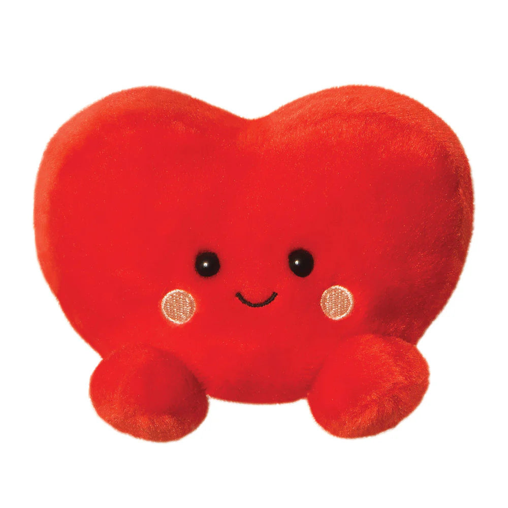 Aurora Palm Pals Amore Heart plush — a bright red heart-shaped soft toy with a gentle smiling face, embroidered blush cheeks, and rounded feet, photographed against a white background