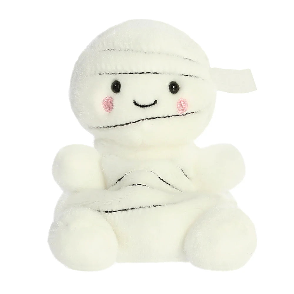 A cute white plush mummy toy with embroidered black facial features, pink cheeks, and wrapped black line details on its head and body, set against a plain white background.