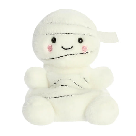 A cute white plush mummy toy with embroidered black facial features, pink cheeks, and wrapped black line details on its head and body, set against a plain white background.