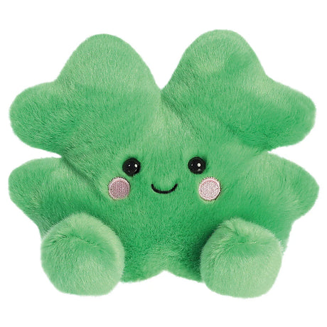 Aurora Palm Pals Chance Clover plush — a bright green four-leaf clover soft toy with a cheerful smiling face, pink embroidered cheeks, and rounded paw-like feet