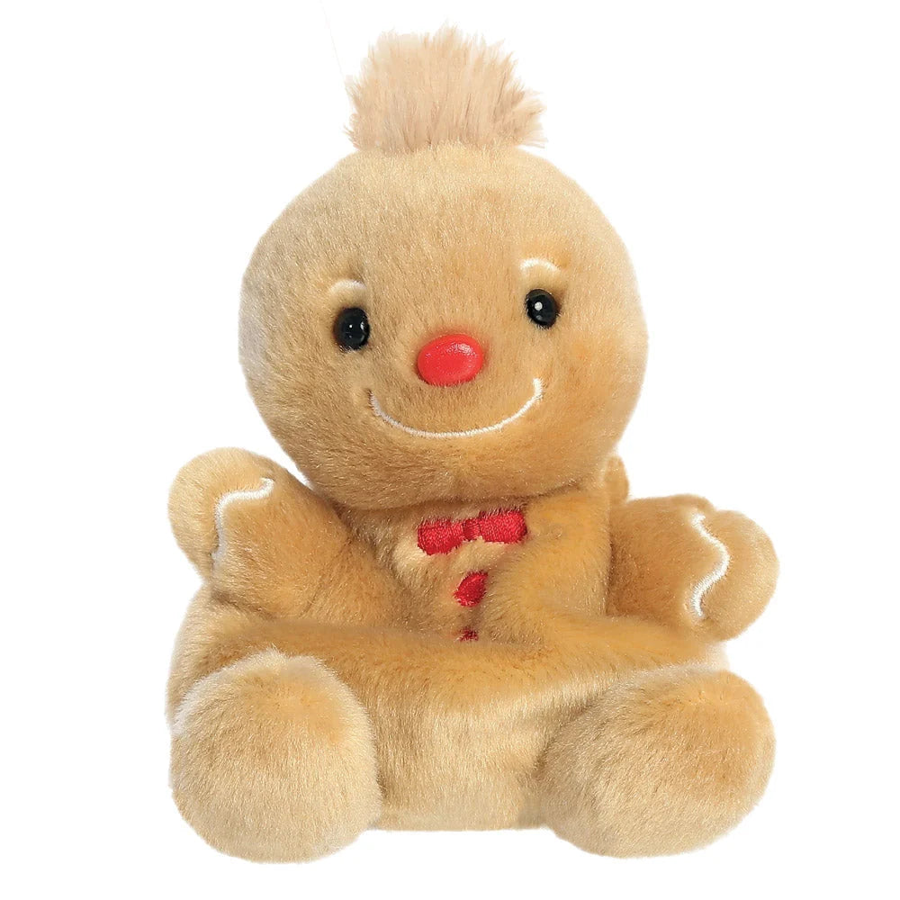 Plush gingerbread man toy with a red nose and smile on a white background