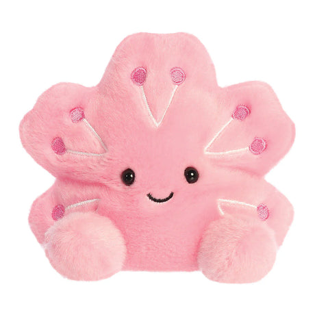 Aurora Palm Pals Hana Cherry Blossom plush — a pink five-petalled sakura flower soft toy with darker pink embroidered details, a smiling face, and rounded rounded feet