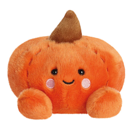 Plush pumpkin toy with a smiling face on a white background
