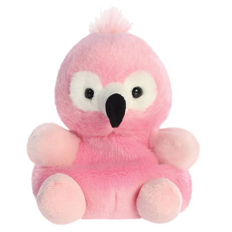 Aurora Palm Pals Pinky Flamingo plush — a bright pink flamingo soft toy with a black beak, large white eye patches, a small pink pompom crest, and a rounded seated pose