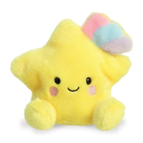 Aurora Palm Pals Pisces Shooting Star plush — a bright yellow star-shaped soft toy with a pastel rainbow tuft of pink, blue, and purple on top, pink blush cheeks, and a cheerful smiling face