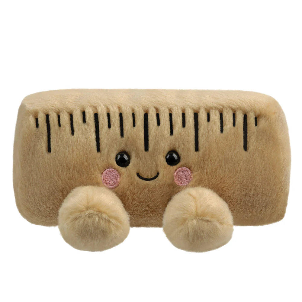 Aurora Palm Pals Roman Ruler plush — a tan rectangular ruler-shaped soft toy with embroidered measurement markings, pink blush cheeks, and a smiling face, sitting against a white background