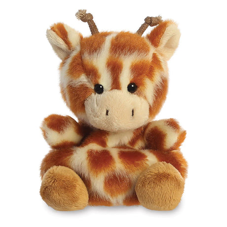 Aurora Palm Pals Safara Giraffe plush — a cream and orange-brown patterned giraffe soft toy with braided rope ossicones, rounded ears, and a compact seated pose against a white background