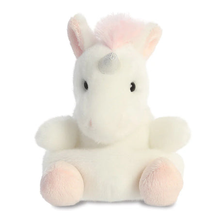 Aurora Palm Pals Sassy Unicorn plush — a soft white unicorn with a shimmery silver horn, pale pink mane, and pink-tinted ears and feet, sitting upright against a white background