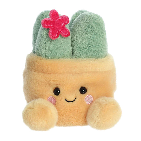 Aurora Palm Pals Seyla Succulent plush — a sandy yellow square pot soft toy with a sage green succulent plant on top decorated with a small red embroidered flower, pink cheeks, and a smiling face